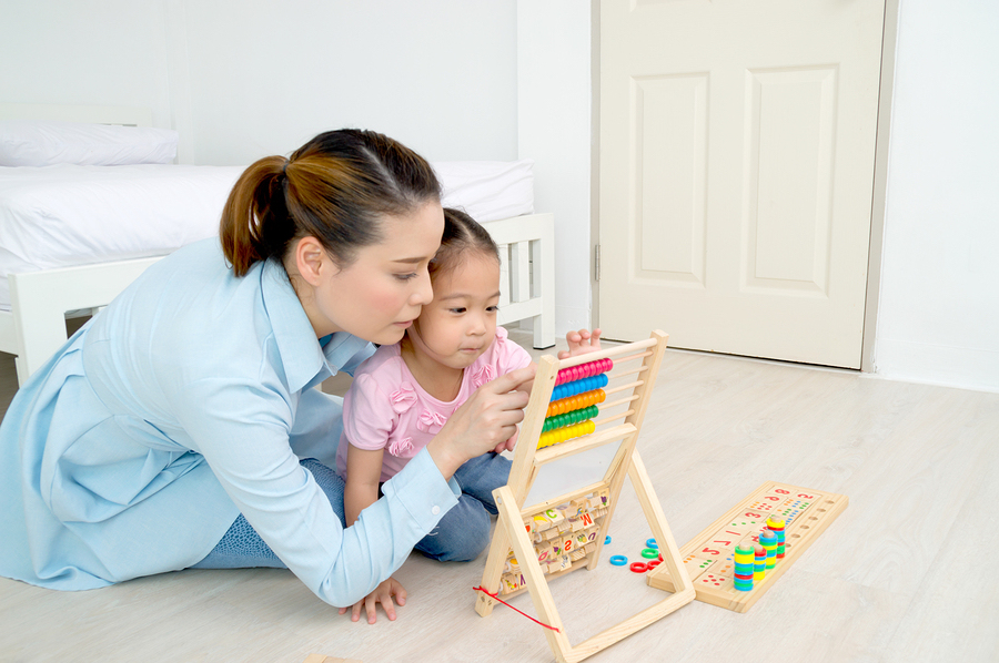 child playing with mom on floor