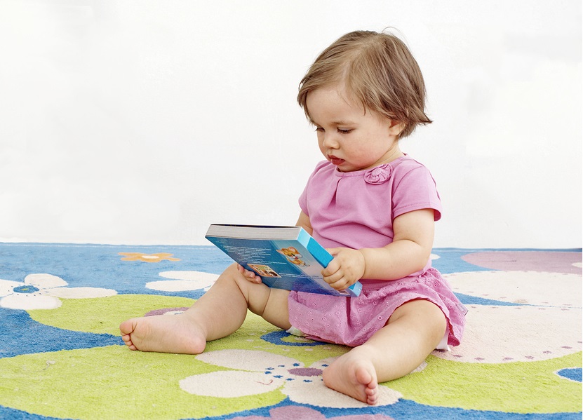 baby girl and book