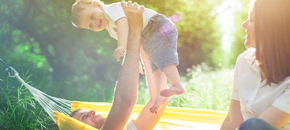 family playing in hammock